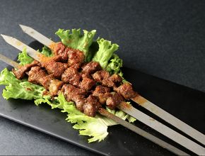 Grilled Meat Skewers on Lettuce